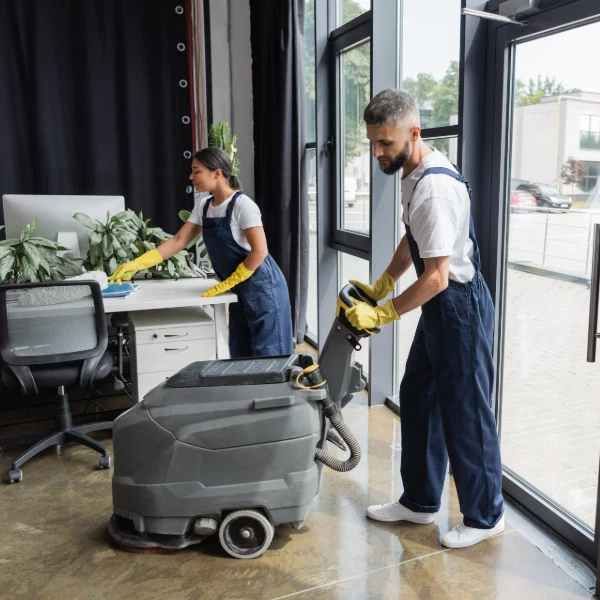 Professional cleaners using commercial cleaning equipment